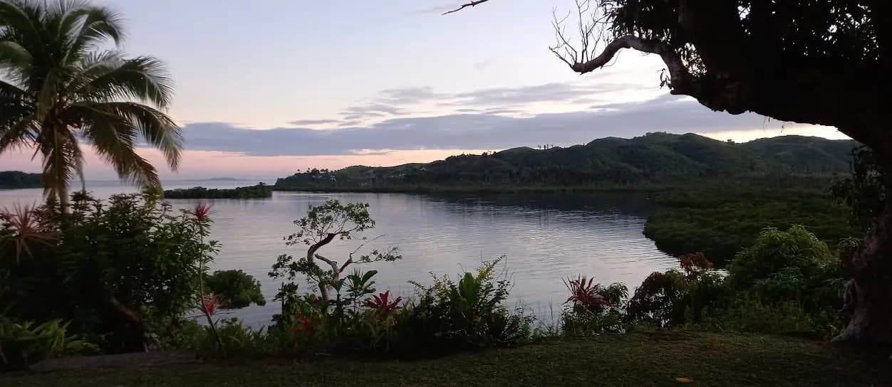 View of the bay and green hills at sunset from Vulavula Dre